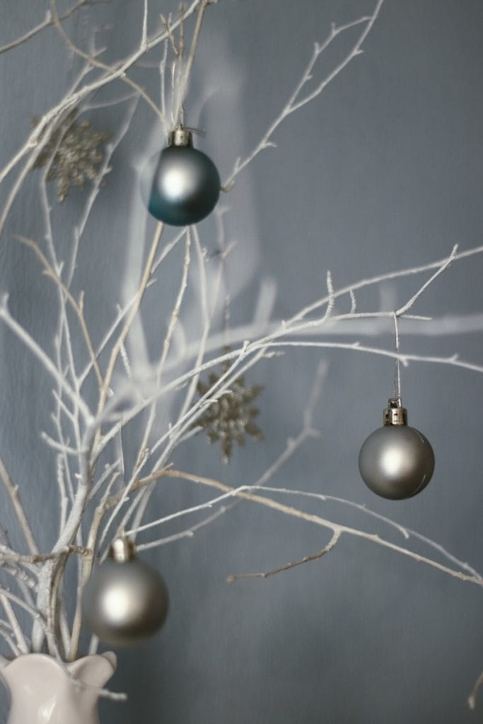 white string lights. Winter trees and silver decor