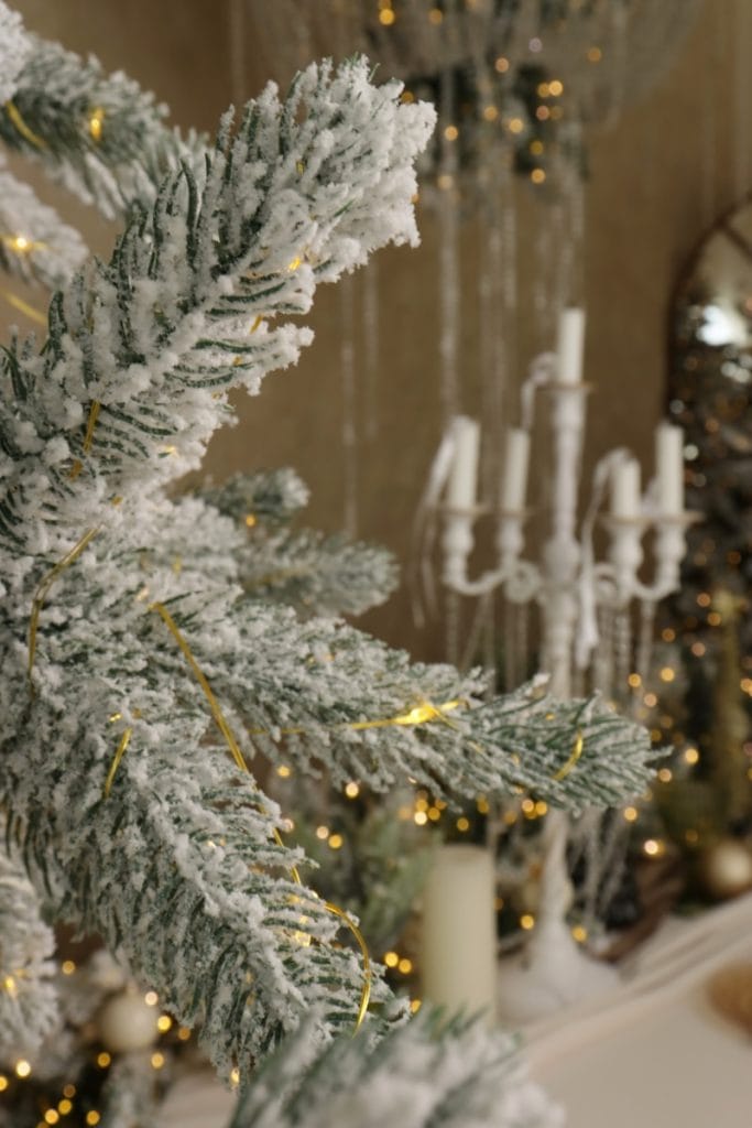 Flocked christmas tree with warm fairy lights.