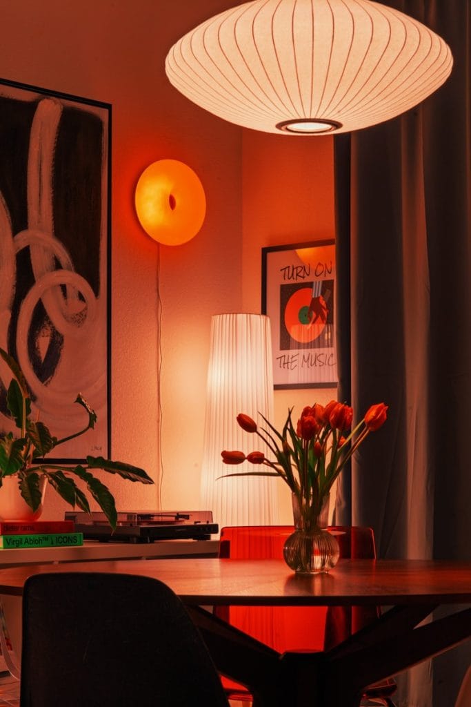 A cozy room with warm lighting and flowers.