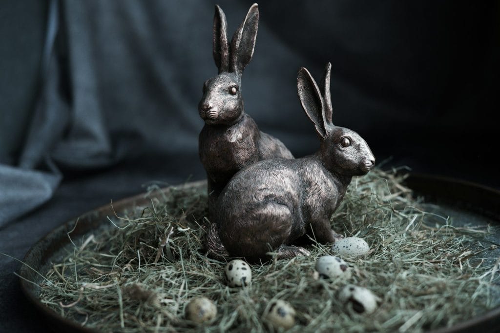 a couple of rabbits sitting on top of a plate
